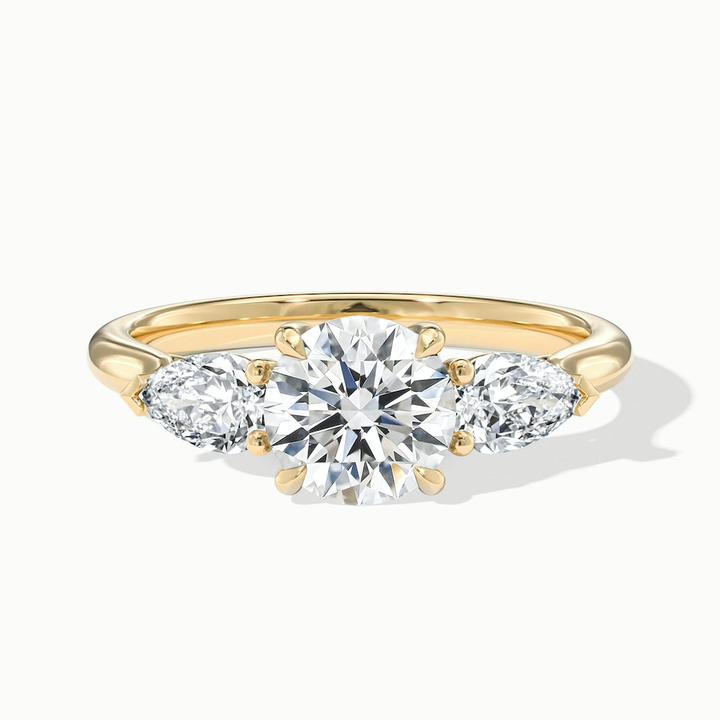 Amaya 2 Carat Round 3 Stone Moissanite Diamond Ring With Pear Side Stone in 14k Yellow Gold