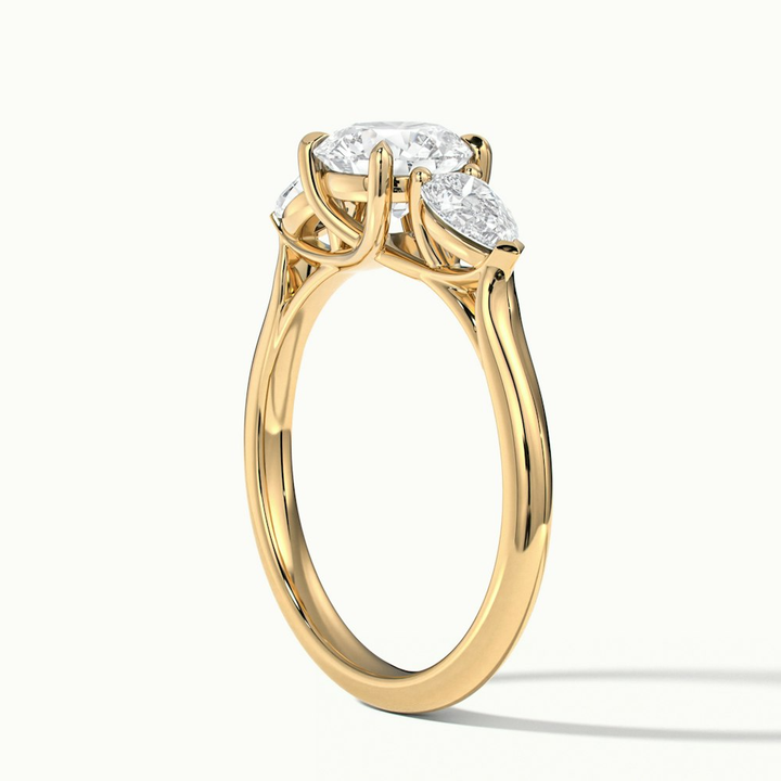 Amaya 1.5 Carat Round 3 Stone Moissanite Diamond Ring With Pear Side Stone in 10k Yellow Gold